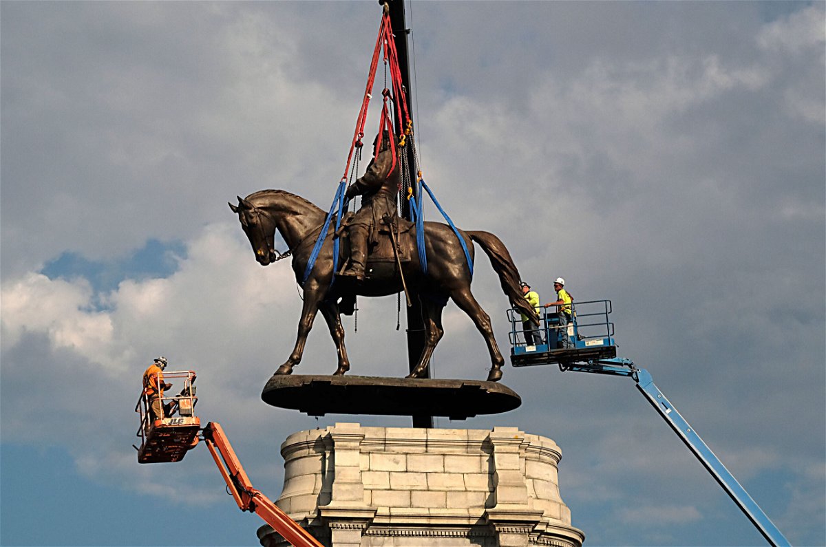 <i>Bob Brown/Pool/Getty Images</i><br/>A statue of Confederate Gen. Robert E. Lee is removed from its pedestal on Monument Avenue on September 8
