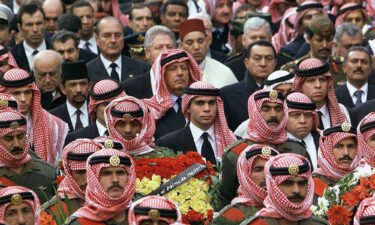 Jordanian King Abdullah (R) and his brother Ali (C) accompany King Hussein's coffin on February 8