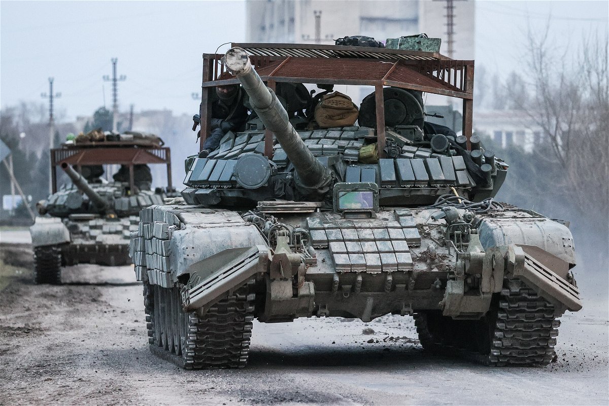 <i>Sergei Malgavko/TASS/Getty Images</i><br/>Russian tanks move across the town of Armyansk in northern Crimea.