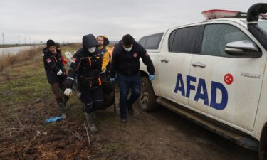 Turkish officials carry the bodies of migrants found frozen to death in Ipsala