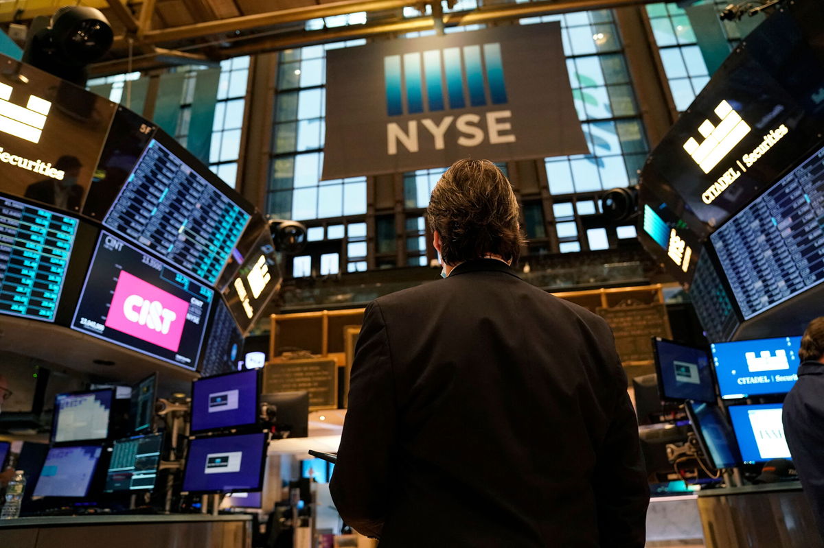 <i>Timothy A. Clary/AFP/Getty Images</i><br/>Traders work on the floor of the New York Stock Exchange at the opening bell January 25. Wall Street firms have figured out a way to beat inflation for their employees by hiking annual bonuses to record amounts.