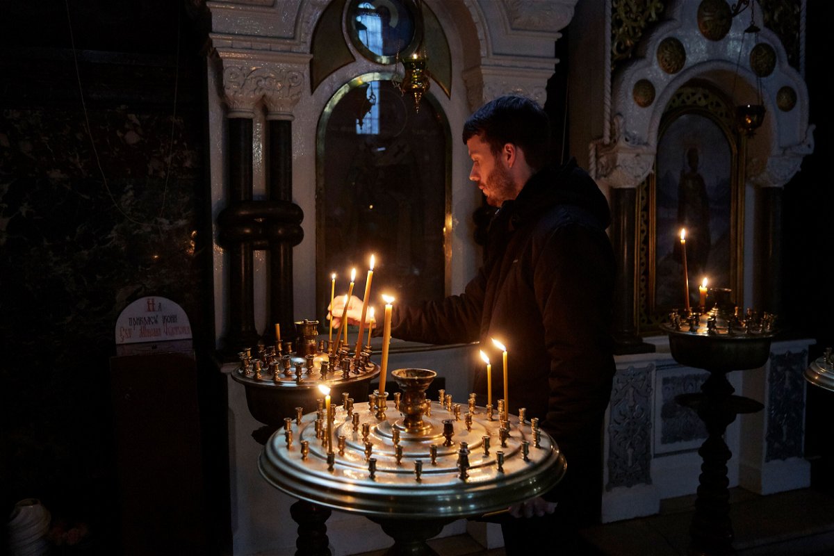 <i>Pierre Crom/Getty Images</i><br/>A man lights a candle in an Orthodox Church in Kyiv