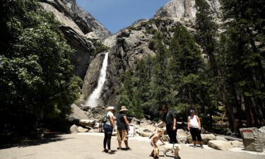 Visitors admire Yosemite Falls in 2020 in Yosemite National Park