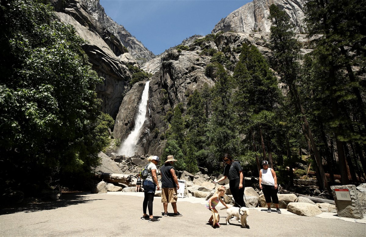 <i>Ezra Shaw/Getty Images</i><br/>Visitors admire Yosemite Falls in 2020 in Yosemite National Park