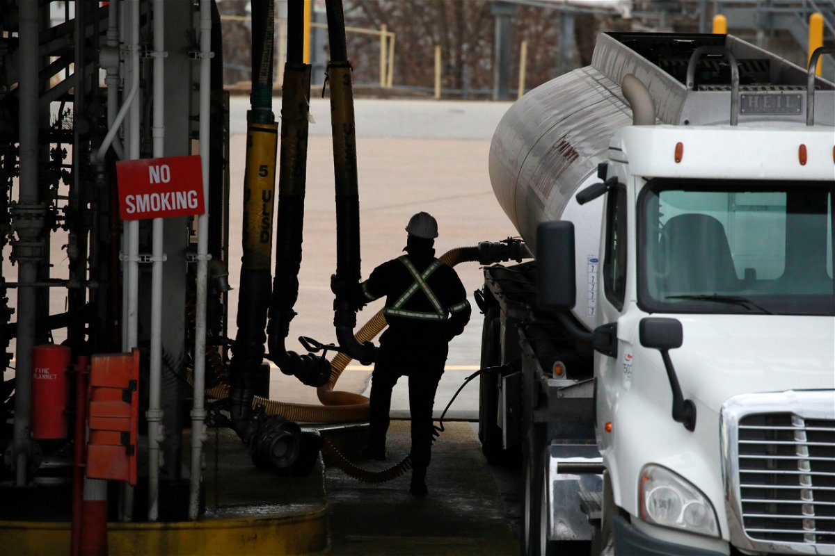 <i>Luke Sharrett/Bloomberg/Getty Images</i><br/>A worker refuels a gasoline tanker truck at the Valero Energy Corp. oil refinery terminal in Memphis