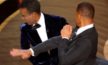Will Smith (R) hits Chris Rock on stage during the 94th Academy Awards in Los Angeles on March 27. The Academy of Motion Pictures Arts and Sciences told members its leaders are "upset and outraged" by Smith's behavior.