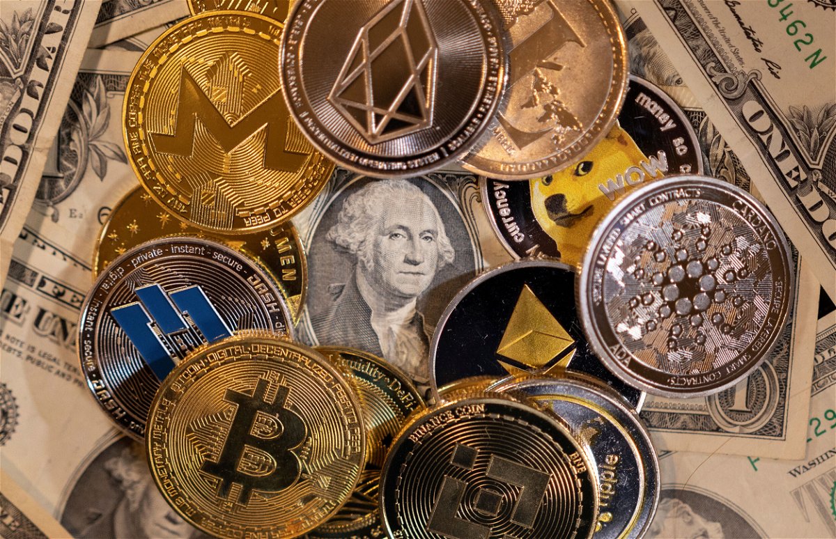 <i>Dado Ruvic/Reuters</i><br/>The US dollar could go digital. Here's what you need to know. Representations of virtual cryptocurrencies are placed on U.S. Dollar banknotes in this illustration taken in November 2021.