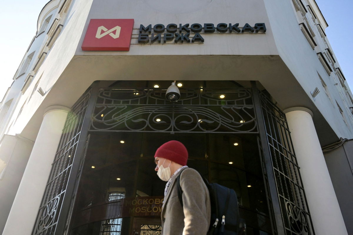 <i>NATALIA KOLESNIKOVA/AFP/Getty Images</i><br/>A man walks past Moscow's stock market building in downtown Moscow on February 28. Russia's stock market opened for the first time in a month on March 24