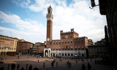 People walk in Piazza del Campo on March 4