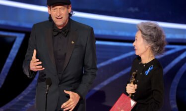 Troy Kotsur accepts the Actor in a Supporting Role award for 'CODA' from Youn Yuh-jung onstage during the 94th Annual Academy Awards at Dolby Theatre on March 27