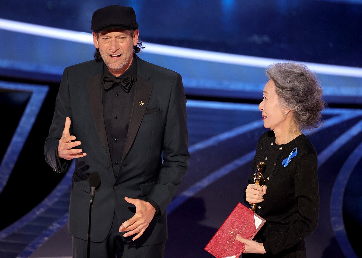 <i>Neilson Barnard/Getty Images</i><br/>Troy Kotsur accepts the Actor in a Supporting Role award for 'CODA' from Youn Yuh-jung onstage during the 94th Annual Academy Awards at Dolby Theatre on March 27