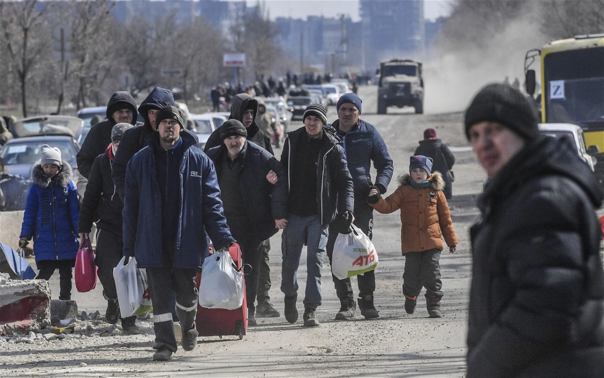 <i>Alexey Kudenko/Sputnik/AP</i><br/>Residents leave the city of Mariupol which has seen intense fighting in recent weeks.