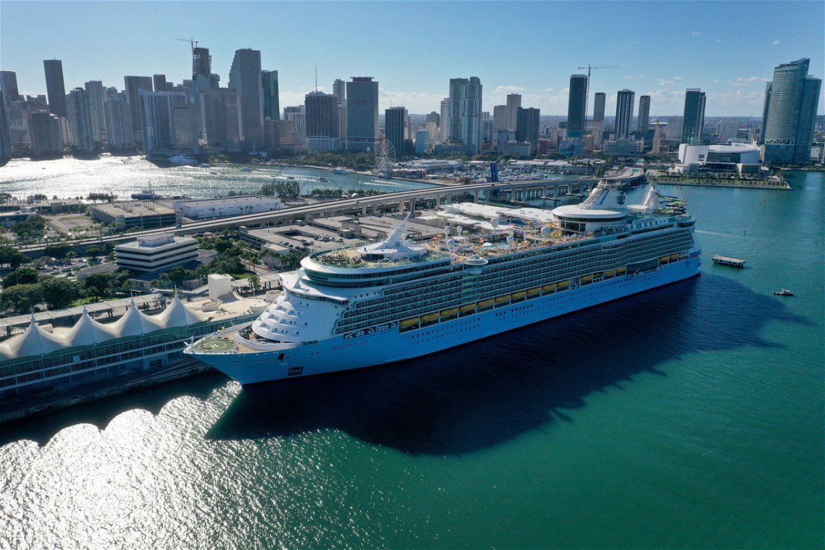 A cruise ship waits for people to embark before leaving PortMiami in December 2021 in Miami