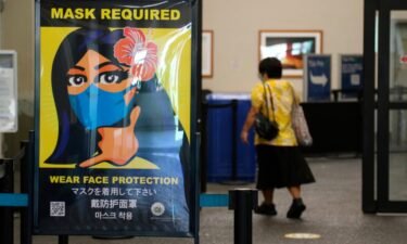 A poster at the international airport in Honolulu in 2020 showing mask requirement.