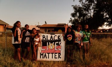 Children from Yuendumu hold a Black Lives Matter sign on March 11