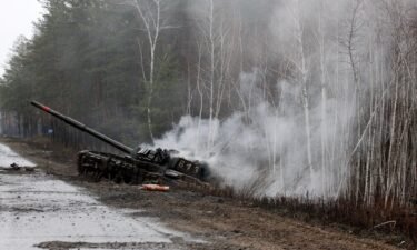 Smoke rises from a Russian tank destroyed by the Ukrainian forces on the side of a road in Lugansk region on February 26. Russia on February 26 ordered its troops to advance in Ukraine "from all directions" as the Ukrainian capital Kyiv imposed a blanket curfew.