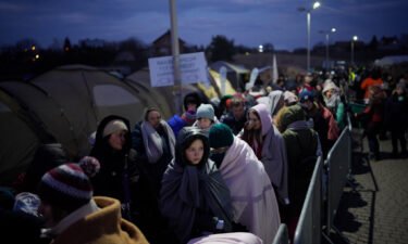 Refugees fleeing war in neighboring Ukraine queue at the Medyka border crossing