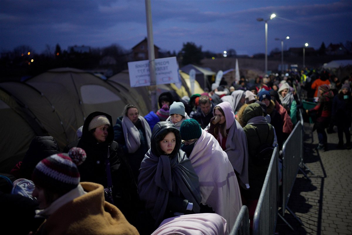 <i>Daniel Cole/AP</i><br/>Refugees fleeing war in neighboring Ukraine queue at the Medyka border crossing