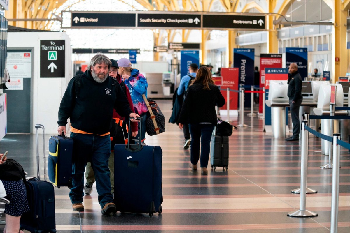 <i>Evan Vucci/AP</i><br/>Passengers walk in the terminal at Ronald Reagan Washington National Airport