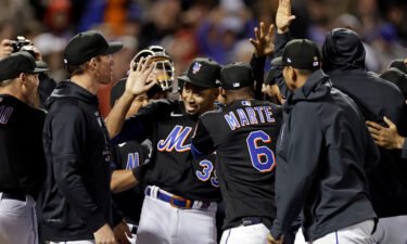 Pitcher Edwin Díaz celebrates with teammates after the Mets threw a combined no-hitter to defeat the Philadelphia Phillies 3-0 in New York.