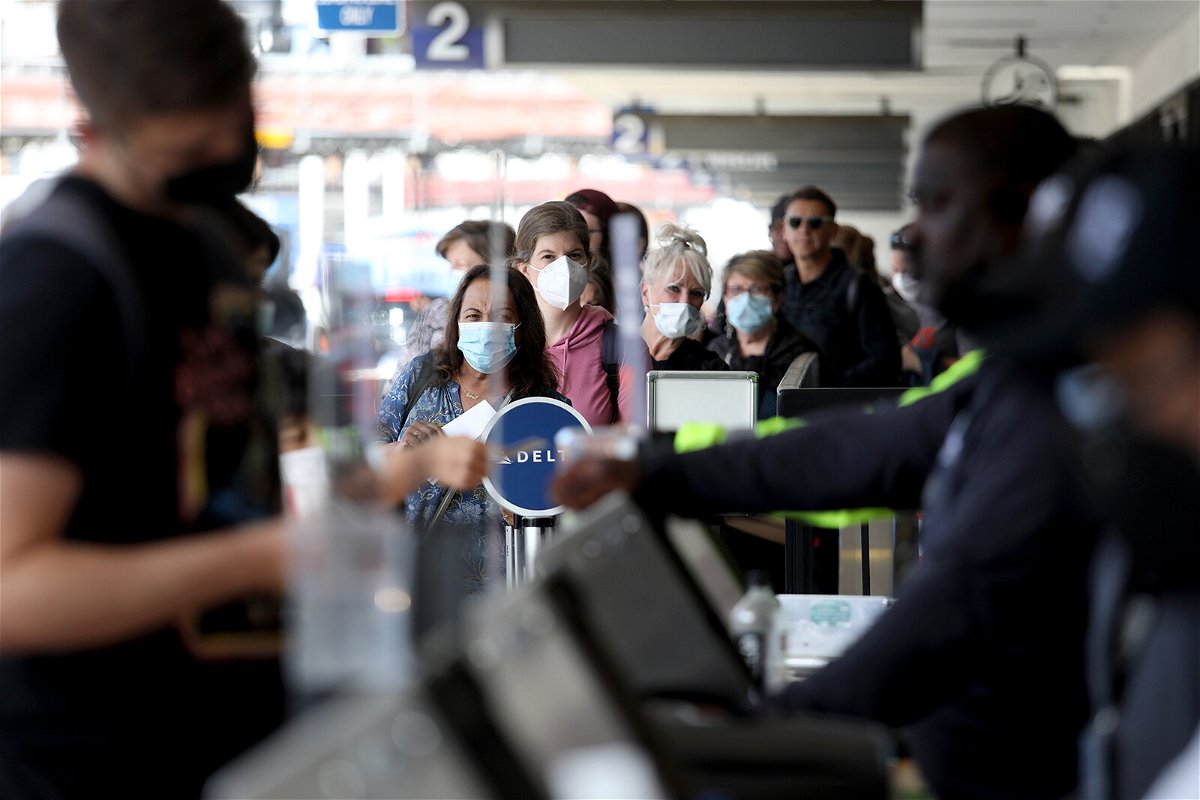 <i>Gary Coronado/Los Angeles Times/Getty images</i><br/>Passengers make their way through Delta Airlines Terminal Two at Los Angeles International Airport on Tuesday