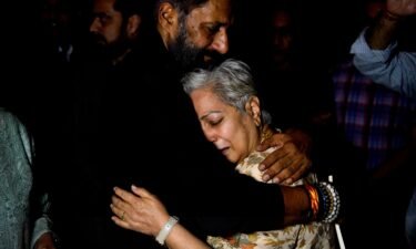 A Kashmiri Pandit woman hugs director Vivek Agnihotri after a special screening for Kashmiri Hindus