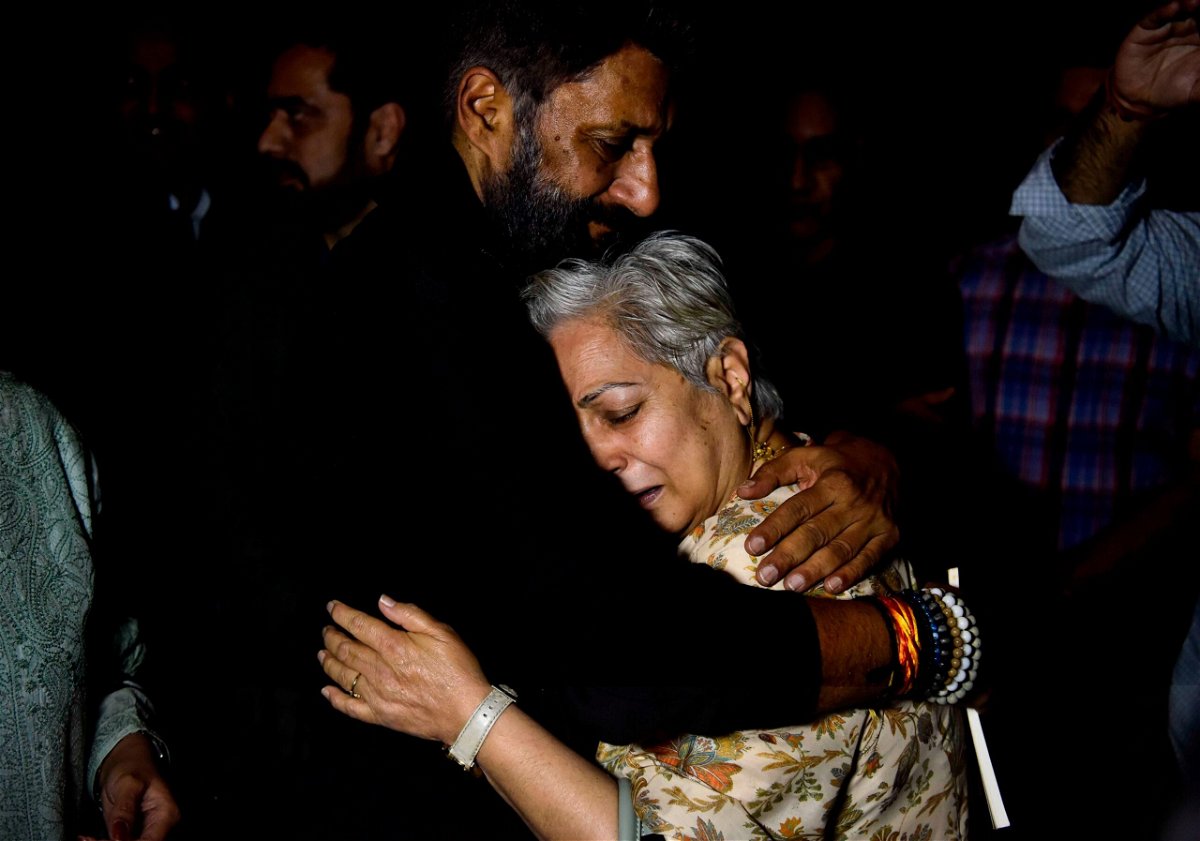 <i>Vipin Kumar/Hindustan Times/Getty Images</i><br/>A Kashmiri Pandit woman hugs director Vivek Agnihotri after a special screening for Kashmiri Hindus