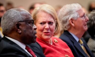 Associate Supreme Court Justice Clarence Thomas sits with his wife and conservative activist Virginia Thomas while he waits to speak at the Heritage Foundation on October 21
