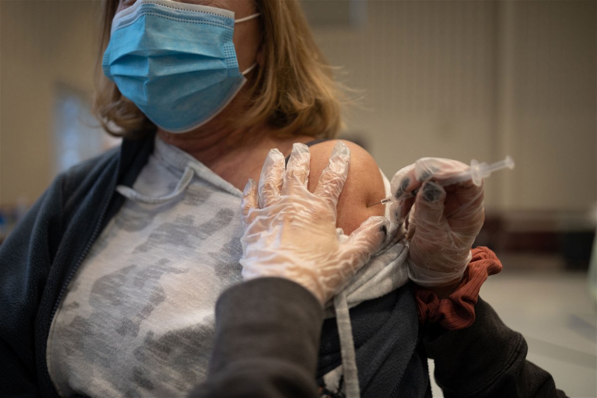 <i>Hannah Beier/Bloomberg/Getty Images</i><br/>A resident receives a Covid-19 booster shot at a vaccine clinic inside Trinity Evangelic Lutheran Church in Lansdale