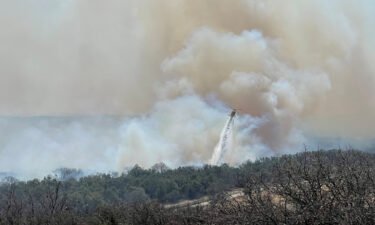 A firefighting helicopter makes a water drop on the Eastland Complex wildfire near Rising Star