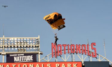 A member of the US Army Parachute Team The Golden Knights lands at Nationals Park before the game between the Washington Nationals and the Arizona Diamondbacks on Wednesday