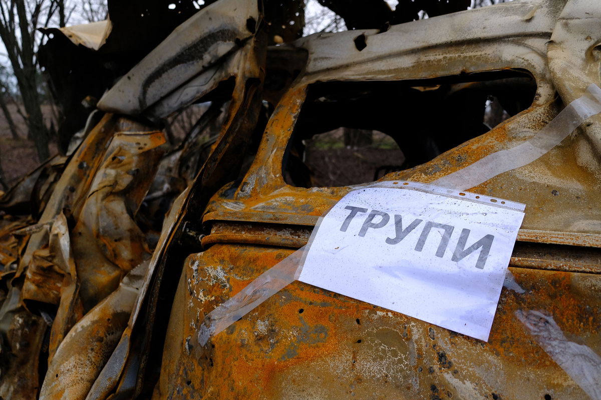 <i>Vasco Cotovio/CNN</i><br/>A sign taped to a burned out car reads 