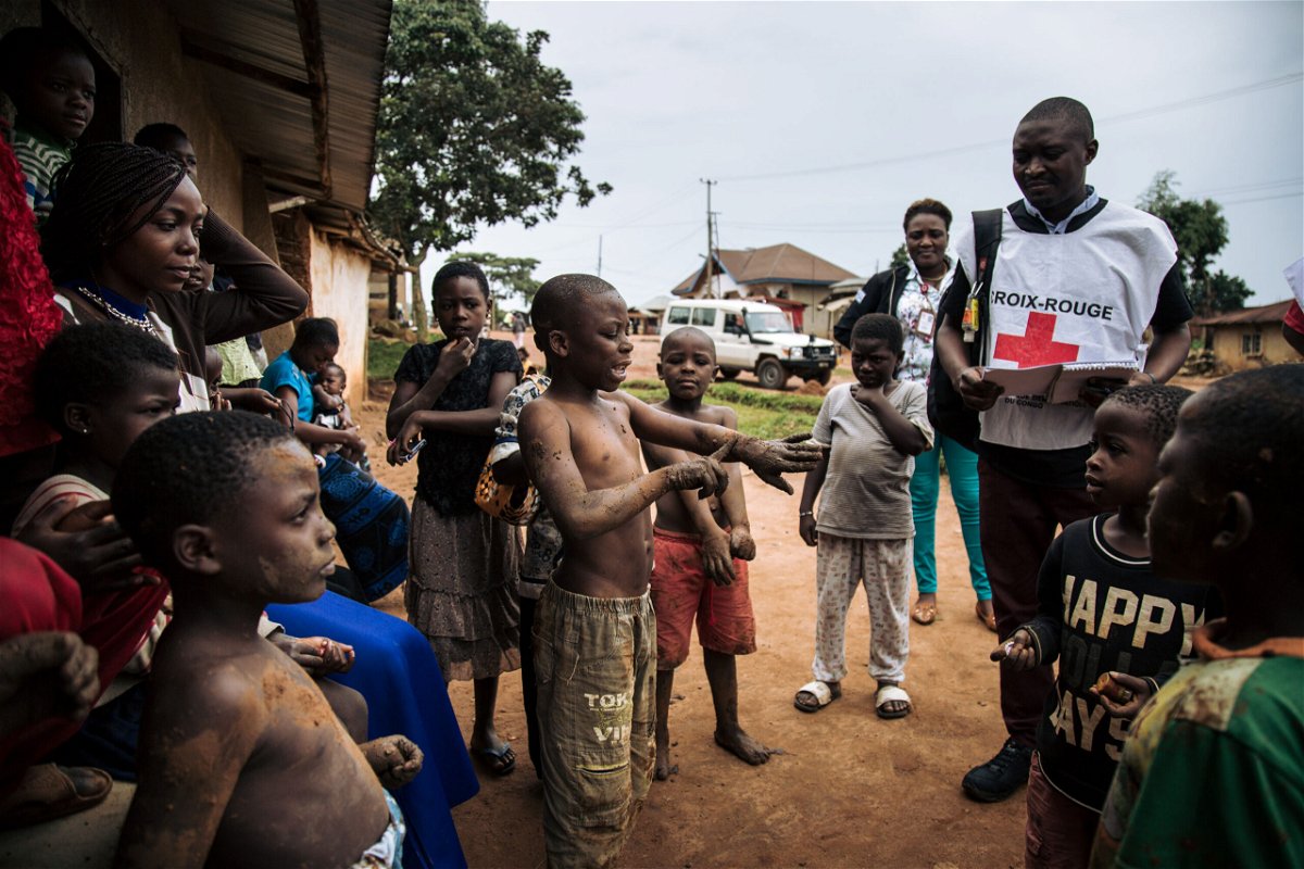 <i>Alexis Huget/AFP/Getty Images</i><br/>Red Cross members go door-to-door in Beni