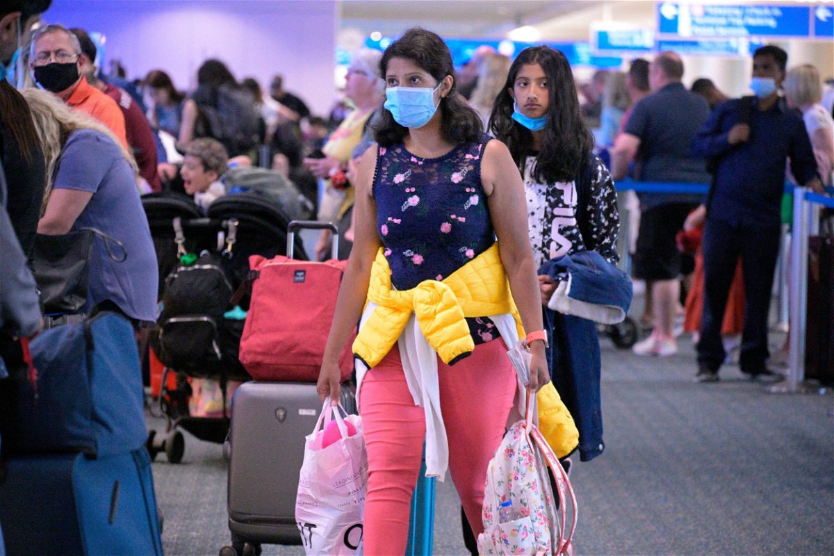 <i>Phelan M. Ebenhack/AP</i><br/>Some people continue to wear face masks this week such as these travelers at Orlando International Airport.