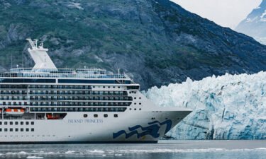 A cruise ship sails in front of Margerie Glacier in Glacier Bay
