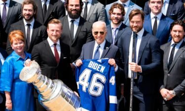 President Joe Biden holds A jersey during a ceremony with the National Hockey Leagues Tampa Bay Lightning to celebrate their 2020 and 2021 Stanley Cup championships on the South Lawn of the White House
