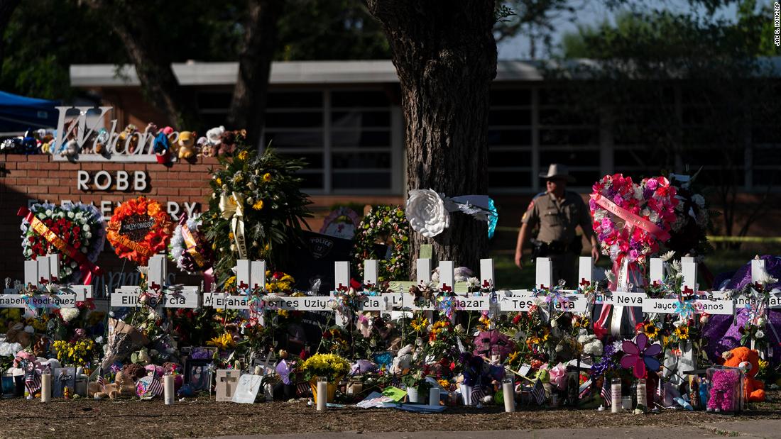 FILE - Flowers and candles are placed around crosses at a memorial outside Robb Elementary School to honor the victims killed in this week's school shooting in Uvalde, Texas, Saturday, May 28, 2022. (AP Photo/Jae C. Hong, File)