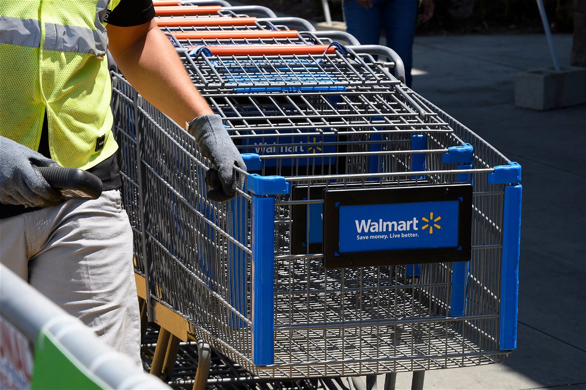 <i>Robyn Beck/AFP/Getty Images</i><br/>An employee gathers shopping carts at Walmart in July 2020 in Burbank