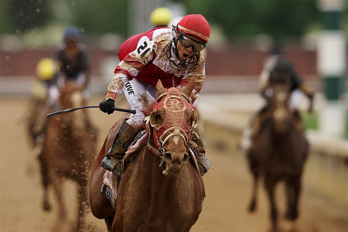 <i>Ezra Shaw/Getty Images</i><br/>Jockey Sonny Leon rides long-shot Rich Strike over the finish line at the Kentucky Derby on May 7.