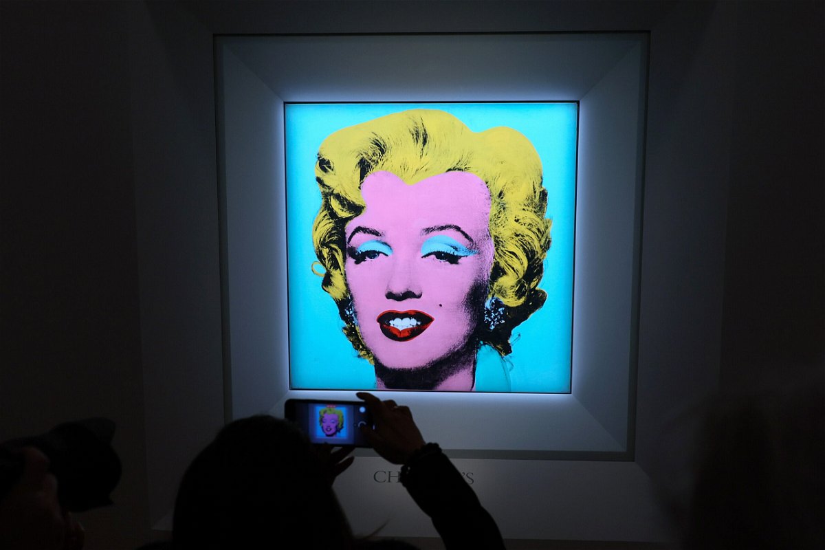 <i>Dia Dipasupil/Getty Images</i><br/>A guest takes a photo during Christie's announcement that it will offer Andy Warhol's 