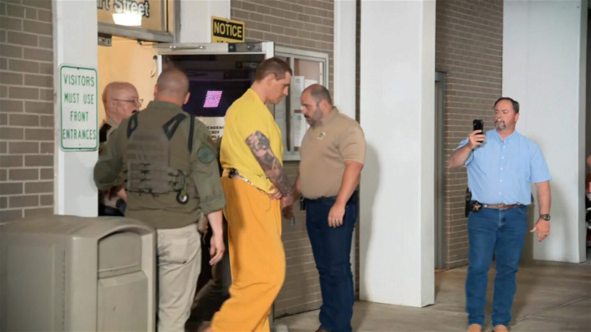 <i>CNN</i><br/>Casey White (center) is seen arriving at the Florence Courthouse.