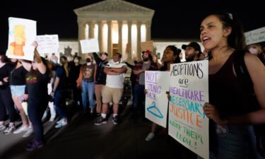 A crowd of people gather outside the Supreme Court on May 3 in Washington