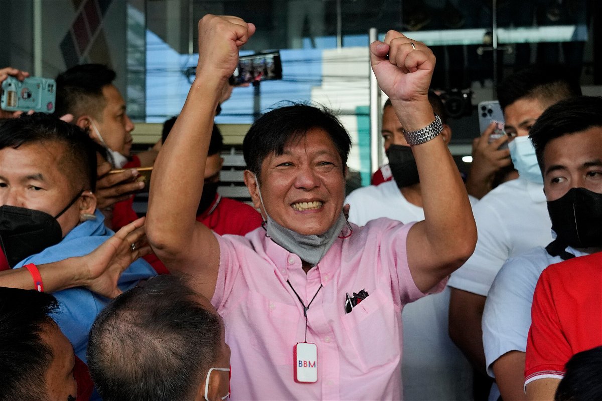 <i>Aaron Favila/AP</i><br/>Marcos Jr asks the world not to judge him by his family's past as he claims victory in Philippines election.