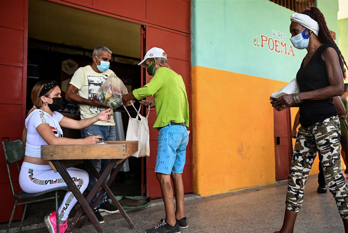 <i>Yamil Lage/AFP/Getty images</i><br/>Cubans collect donated food at a supermarket in Havana in August 2021.
