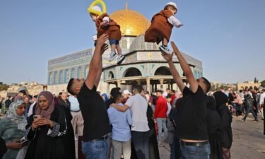 Muslims play with their children in front of the Dome of the Rock after the Eid al-Fitr prayer in Jerusalem's Old City on May 2.