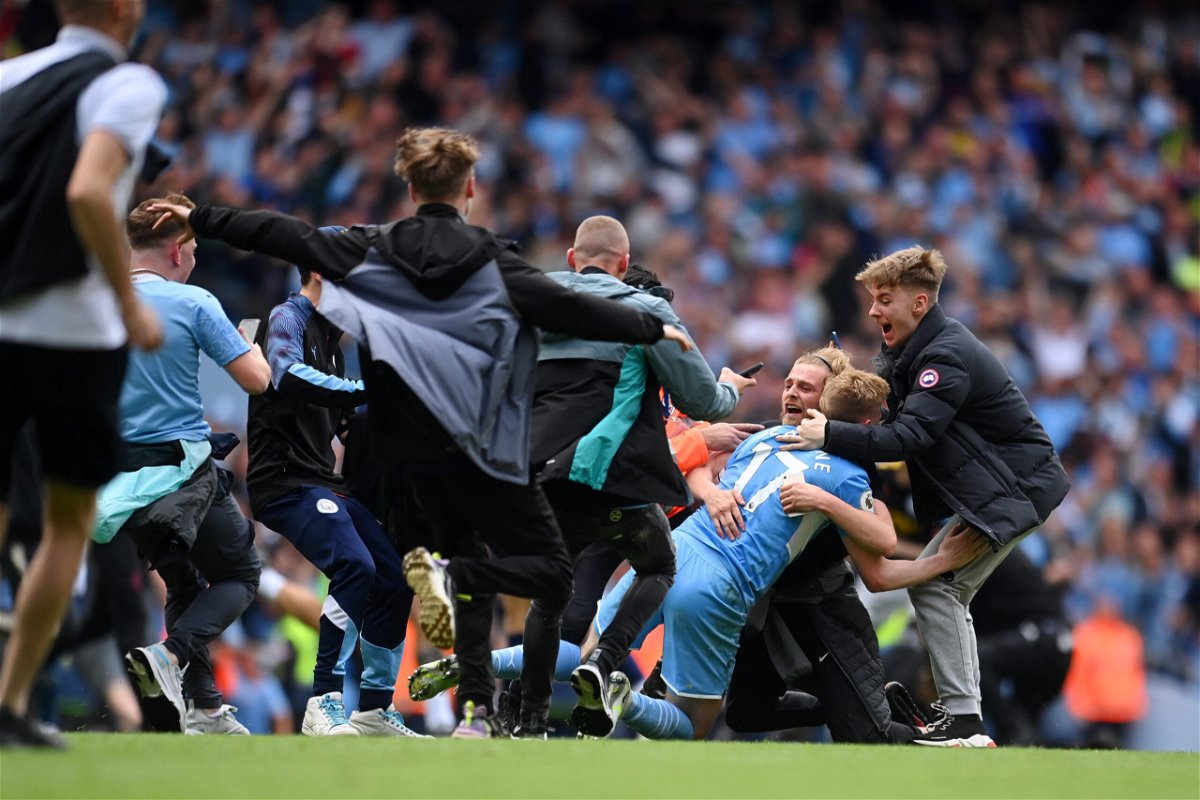 <i>Michael Regan/Getty Images Europe/Getty Images</i><br/>Kevin De Bruyne is mobbed by Manchester City fans after the club wins the Premier League.