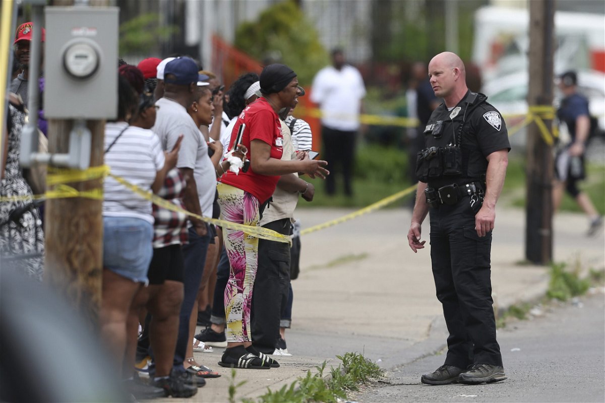<i>Joshua Bessex/AP</i><br/>Police speak to bystanders after the shooting at a supermarket on May 14