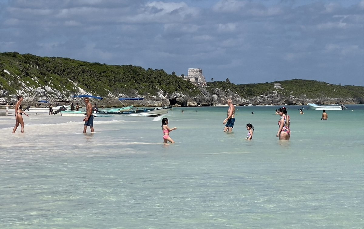 <i>Daniel Slim/AFP via Getty Images</i><br/>People spend time at Tulum beach