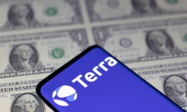 Smartphone with Terra logo is placed on displayed U.S. dollars in this illustration taken May 11. On Twitter and Reddit