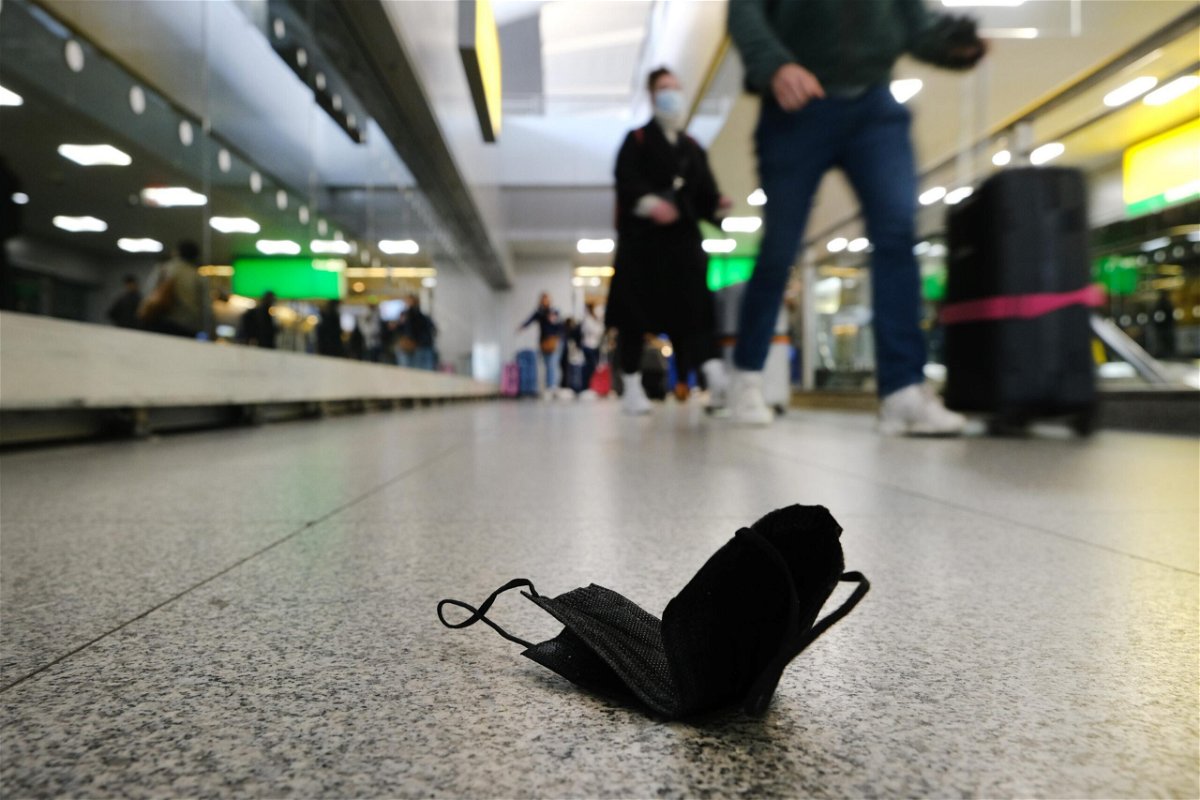<i>Spencer Platt/Getty Images</i><br/>A mask is seen on the ground at John F.  Kennedy Airport on April 19 in New York City. As health officials warn of rising Covid-19 infections and hospitalizations